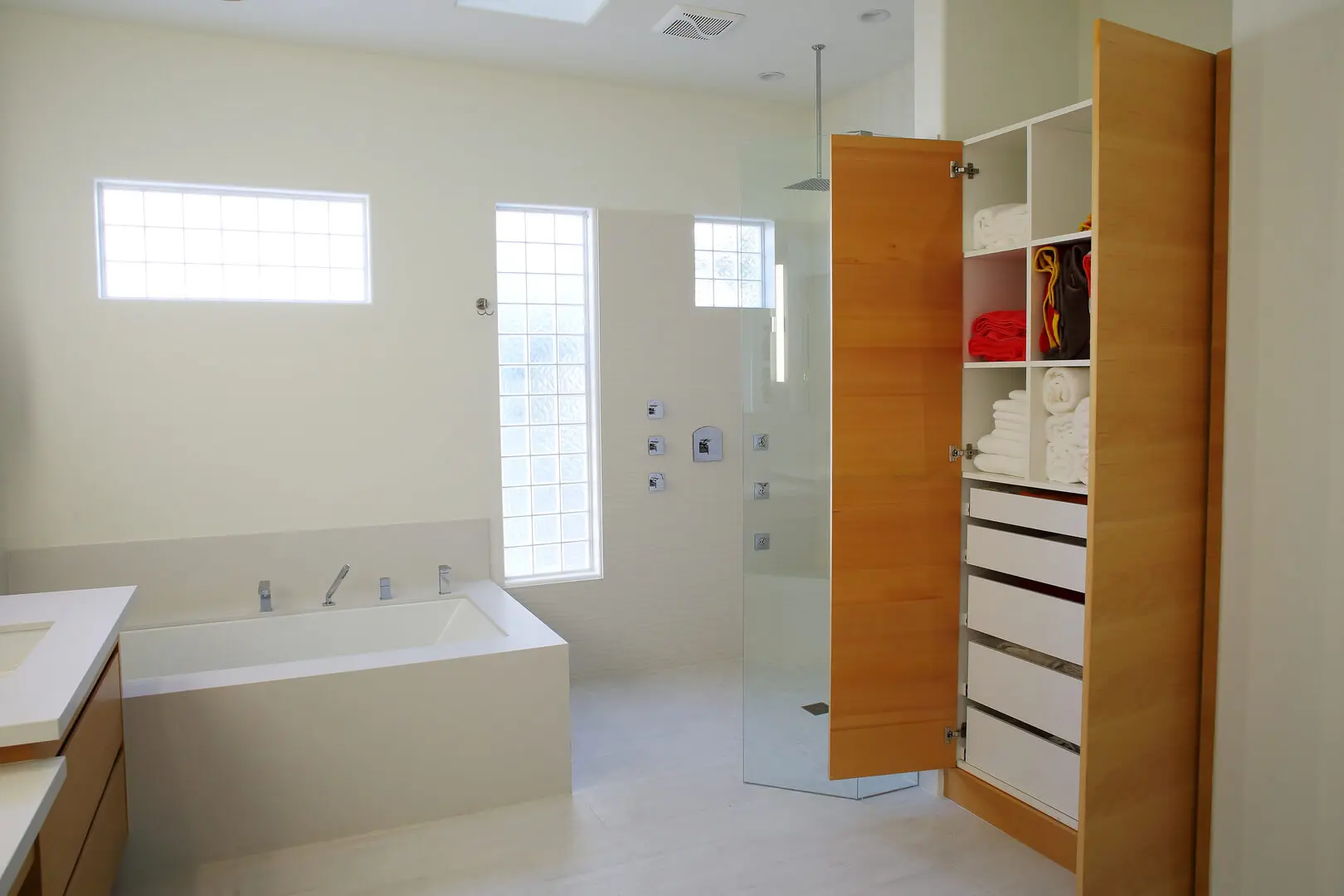A bathroom with a tub, shower and toilet.