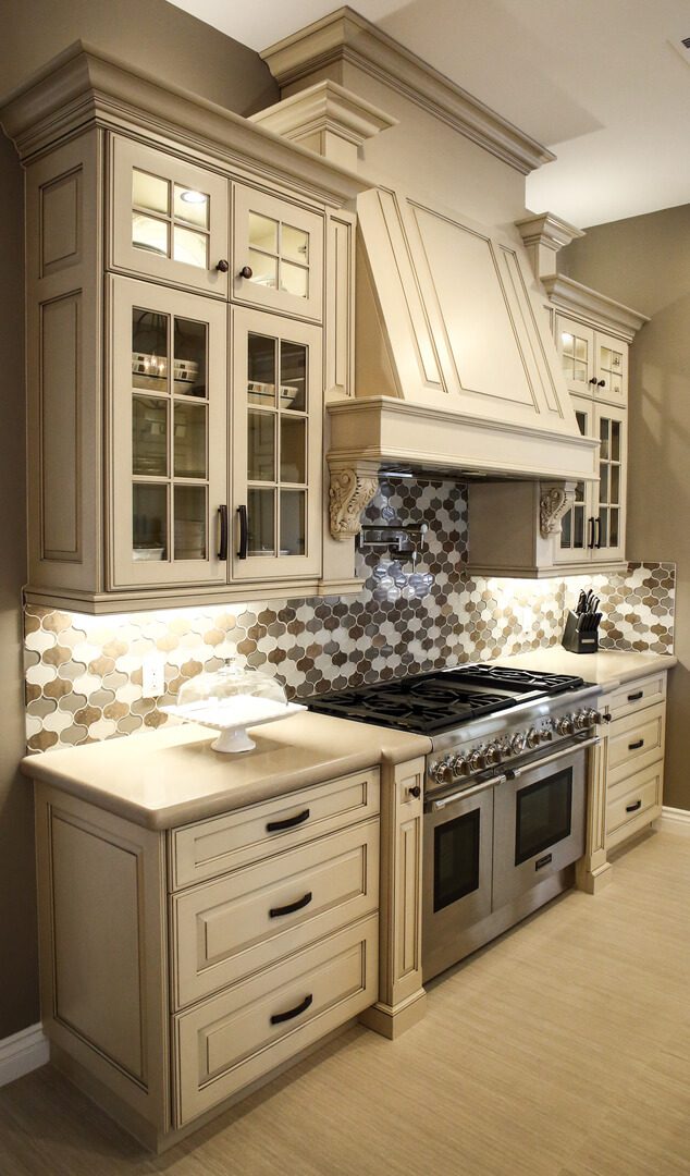 A kitchen with white cabinets and a stove.