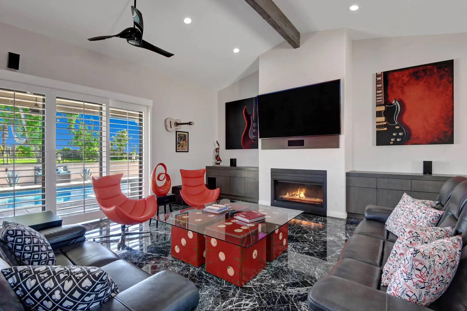 A living room with a fire place and red chairs