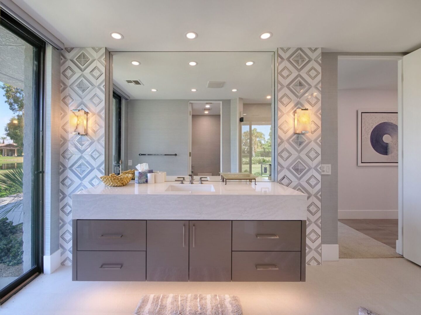 A bathroom with a large mirror and two sinks.